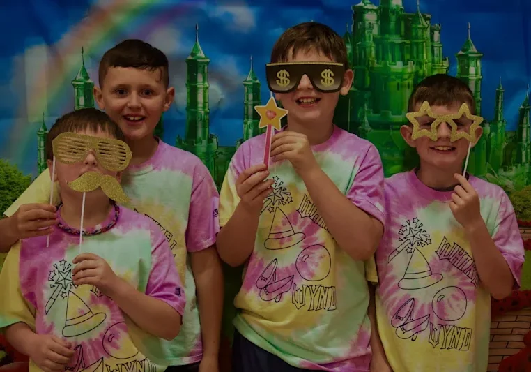 Four kids with novelty props in castle backdrop